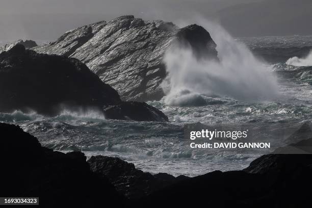 Waves crash against the rocks along the coastline on Achill Island in the west of Ireland on September 25, 2023.