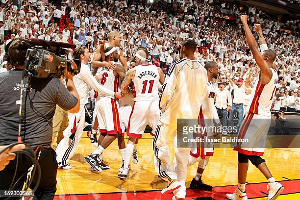 LeBron James of the Miami Heat celebrates with teammates after his game-winning layup in overtime against the Indiana Pacers in Game One of the...