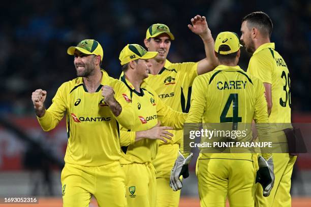 Australia's players celebrate after the dismissal of India's Suryakumar Yadav during the third and final one-day international cricket match between...