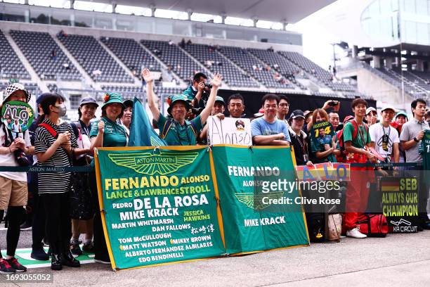 Fernando Alonso of Spain and Aston Martin F1 Team fans show their support in the Pitlane during previews ahead of the F1 Grand Prix of Japan at...