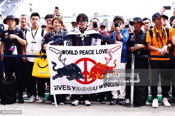 Red Bull Racing fans wait in the Pitlane during previews ahead of the F1 Grand Prix of Japan at Suzuka International Racing Course on September 21,...