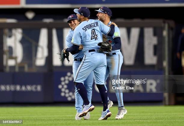 Matt Chapman,Kevin Kiermaier and George Springer of the Toronto Blue Jays celebrate the win over the New York Yankees at Yankee Stadium on September...