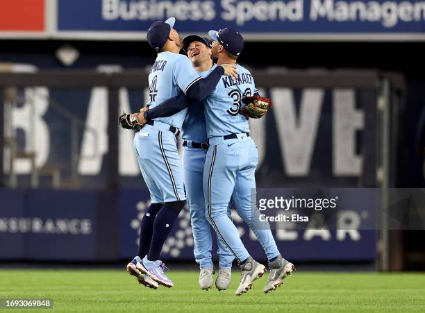 Matt Chapman,Kevin Kiermaier and George Springer of the Toronto Blue Jays celebrate the win over the New York Yankees at Yankee Stadium on September...