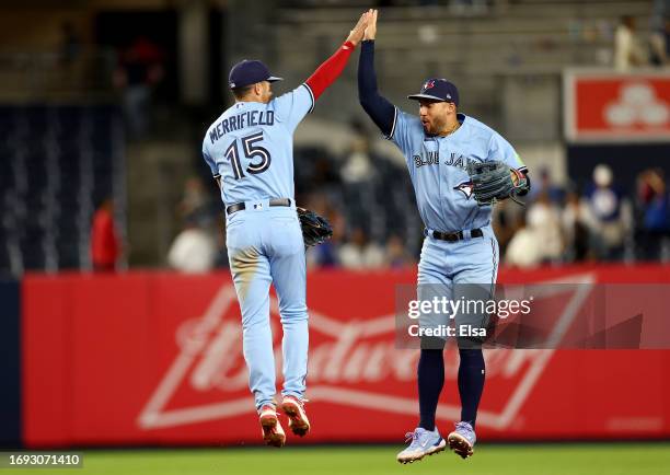 Whit Merrifield and George Springer of the Toronto Blue Jays celebrate the win over the New York Yankees at Yankee Stadium on September 20, 2023 in...