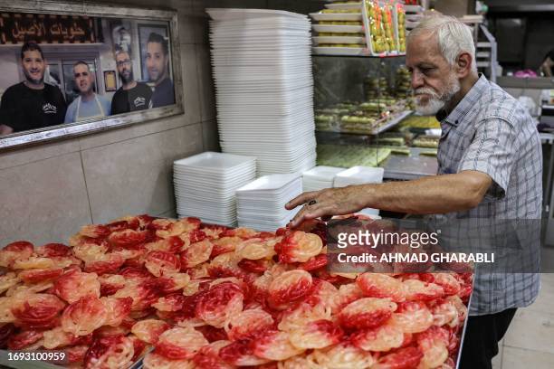 Vendor sells traditional sweets in Jerusalem's Old City on September 27, 2023 as Palestinians celebrate the Muslim Prophet Mohammed's birthday.
