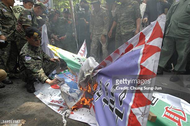 South Korean Vietnam War veterans burn anti-Japan placards during their rally in front of Japanese embassy on May 23, 2013 in Seoul, South Korea....