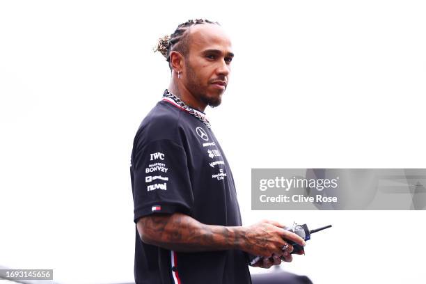 Lewis Hamilton of Great Britain and Mercedes races radio control cars during previews ahead of the F1 Grand Prix of Japan at Suzuka International...