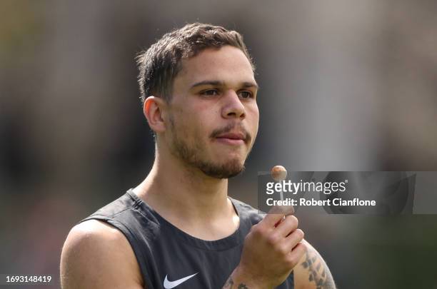 Bobby Hill of the Magpies is seen with a lollipop during a Collingwood Magpies AFL training session at Olympic Park Oval on September 21, 2023 in...