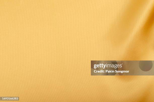 gold color fabric cloth polyester texture and textile background. - roll up banner stock-fotos und bilder