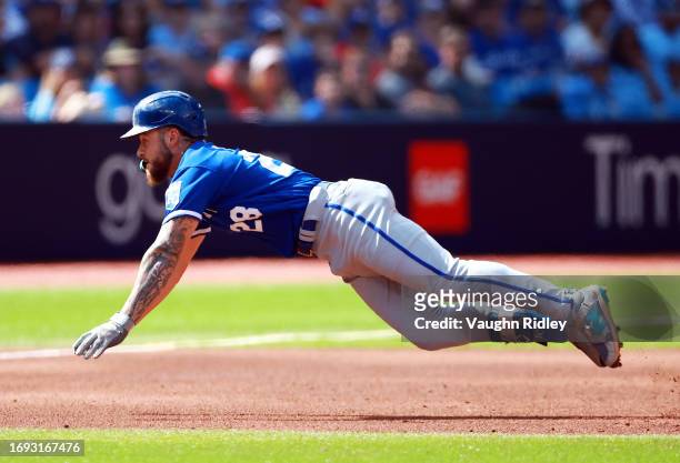 Kyle Isbel of the Kansas City Royals dives into third base after hitting a triple in the sixth inning against the Toronto Blue Jays at Rogers Centre...