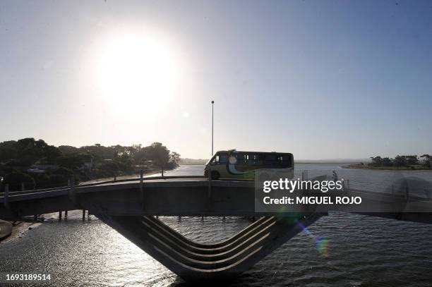 Minibus drives over the emblematic La Barra bridge in La Barra, near Punta del Este, Maldonado, 140 km east of Montevideo, on January 8, 2010. Punta...