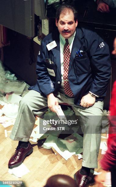 Trader on the floor of the New York Stock Exchange sits at his post at the end of a day which saw the Dow Jones Industrial Average drop 512.61...