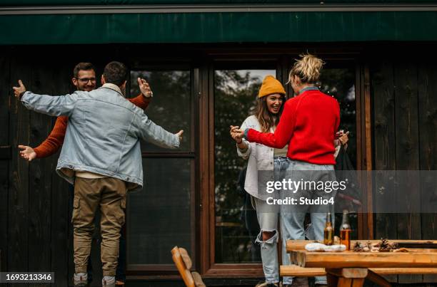 the joyous ambiance of a garden party, with a diverse group of people relishing a shared meal amidst nature's beauty - the party arrivals stock pictures, royalty-free photos & images