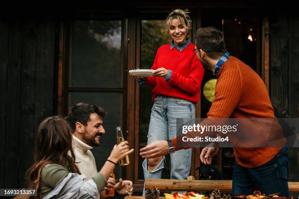 the joyous ambiance of a garden party, with a diverse group of people relishing a shared meal amidst nature's beauty - the party arrivals stock pictures, royalty-free photos & images