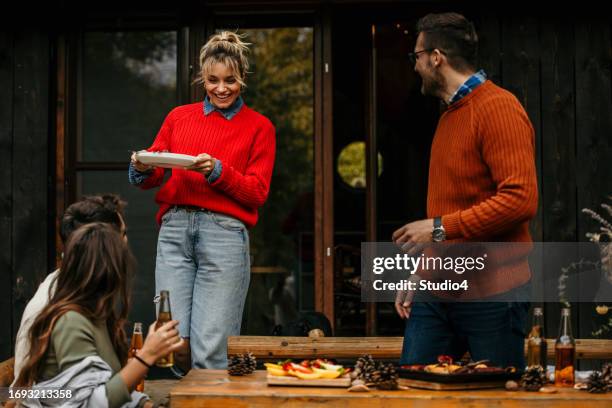 the joyous ambiance of a garden party, with a diverse group of people relishing a shared meal amidst nature's beauty - the party arrivals stock pictures, royalty-free photos & images