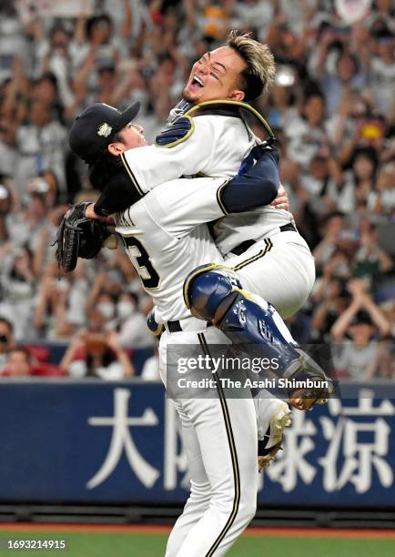 Soichiro Yamazaki and Tomoya Mori of the Orix Buffaloes celebrate winning the Pacific League season champions following the game against Chiba Lotte...