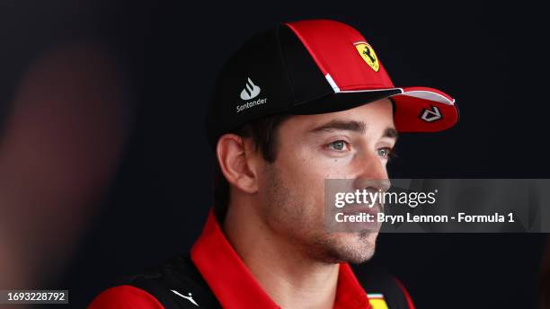 Charles Leclerc of Monaco and Ferrari talks to the media in the Paddock during previews ahead of the F1 Grand Prix of Japan at Suzuka International...