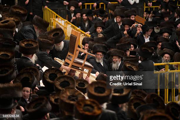 Believers carry their Rabbi's chair as tens of thousands of Ultra-Orthodox Jews of the Belz Hasidic Dynasty take part in the wedding ceremony of...