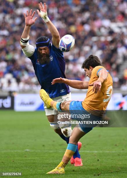 Uruguay's scrum-half Santiago Arata kicks the ball in front of Namibia's flanker Pieter-Jean Van Lill during the France 2023 Rugby World Cup Pool A...