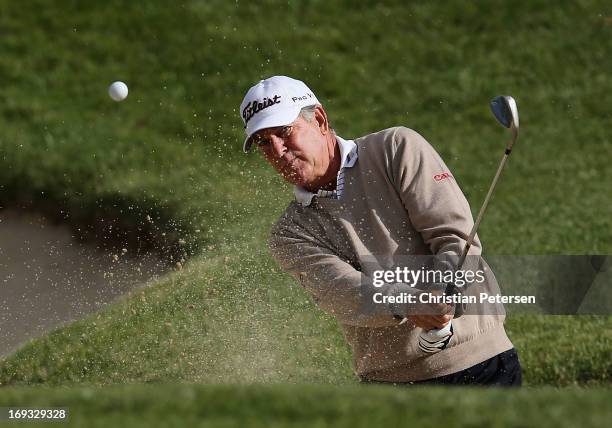 Jay Haas chips from the bunker onto the fourth hole green during Round One of the Senior PGA Championship presented by KitchenAid at Bellerive...