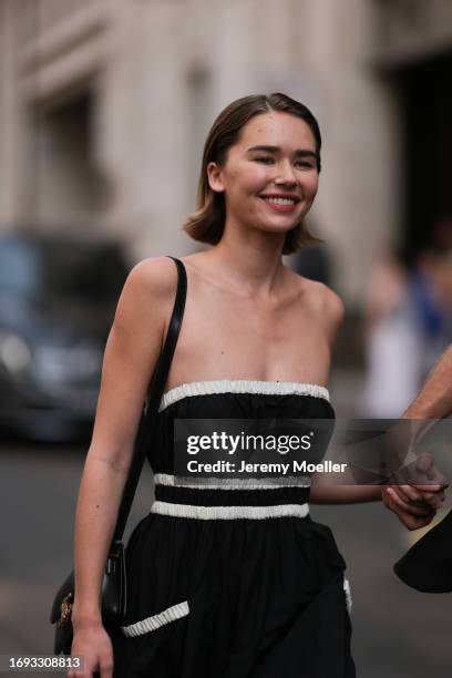 Gabriella Brooks is seen outside Molly Goddard show wearing black dress with white details and beige ballet flats during London Fashion Week...