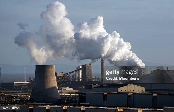 Vapor rises from cooling towers at the steel works operated by Tata Steel Ltd. In Port Talbot, U.K. On Wednesday, May 22, 2013. Tata Steel Ltd.,...