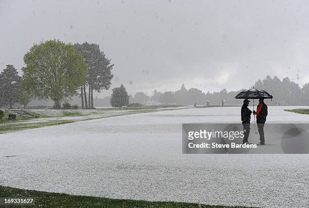 Players shelter from hailstones as play is suspended during the Glenmuir PGA Professional Championship Regional Qualifier at Hindhead Golf Club on...