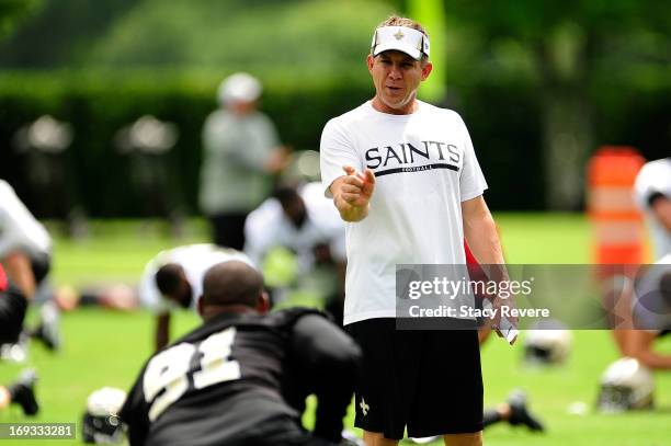 Head coach Sean Payton of the New Orleans Saints speaks with Will Smith during OTA's, organized team activities, at the Saints training facility on...