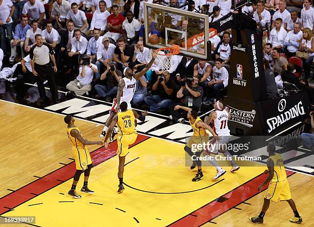 LeBron James of the Miami Heat drives to the basket against Paul George of the Indiana Pacers during Game One of the Eastern Conference Finals at...