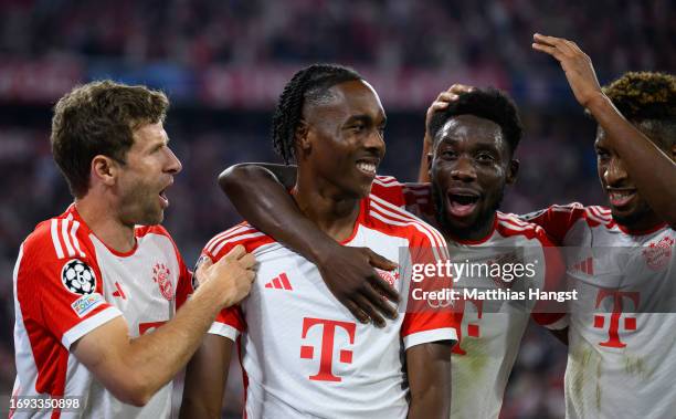 Mathys Tel of Bayern Munich celebrates with team mate Alphonso Davies after scoring their sides fourth goal during the UEFA Champions League match...
