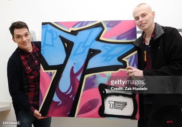 Graffiti artist Ben McKay and cancer patient Alex Gaunt, 18 from Caterham celebrate the first birthday of Teenage Cancer Unit by creating a special...