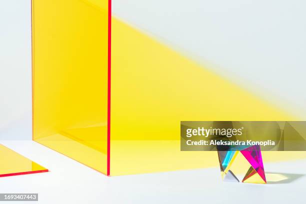 abstract 3d scene with rainbow colorful glass prism podium and yellow geometric figures on white background with copy space. - beauty cosmetic luxury studio background stock-fotos und bilder