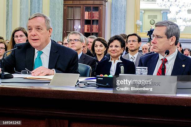 Chicago billionaire Penny Pritzker, center, looks on as Senator Dick Durbin, a Democrat from Illinois, left, and Mark Kirk, a Republican from...