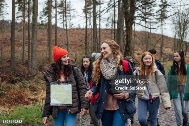 teacher leading the field trip - following map stock pictures, royalty-free photos & images