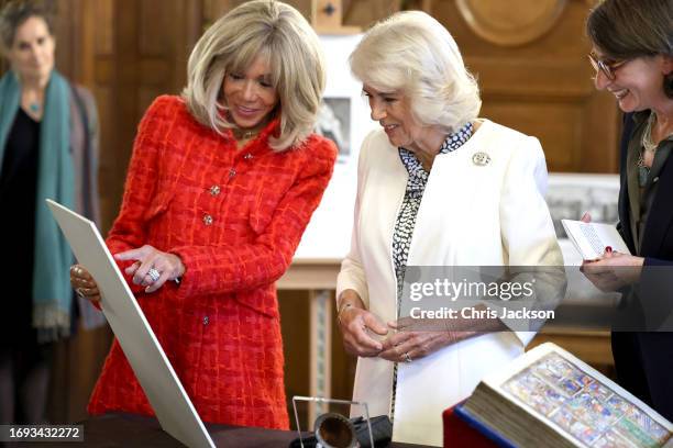 Brigitte Macron and Queen Camilla share a joke as she points at an Asterix cartoon ahead of the launch of a new UK - France Literary Prize during a...