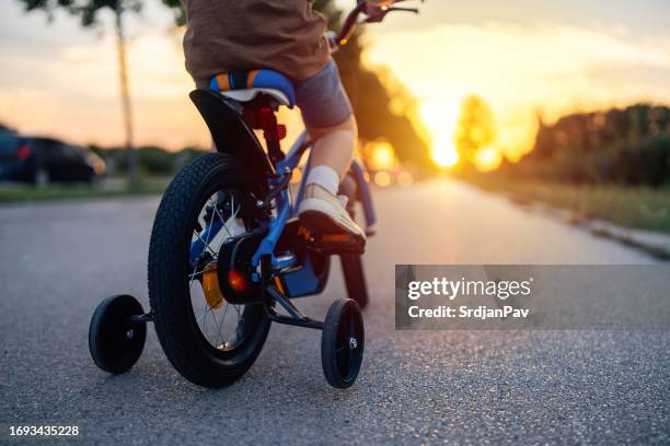 boy riding a bicycle - kids on bikes stock pictures, royalty-free photos & images