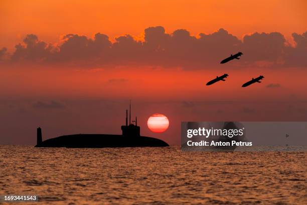 launching missiles at a submarine. submarine at sea at sunset. - military convoy stock pictures, royalty-free photos & images