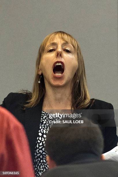 Medea Benjamin, a protester and co-founder of Code Pink, shouts "Close Guantanamo" as US President Barack Obama speaks about his administration's...