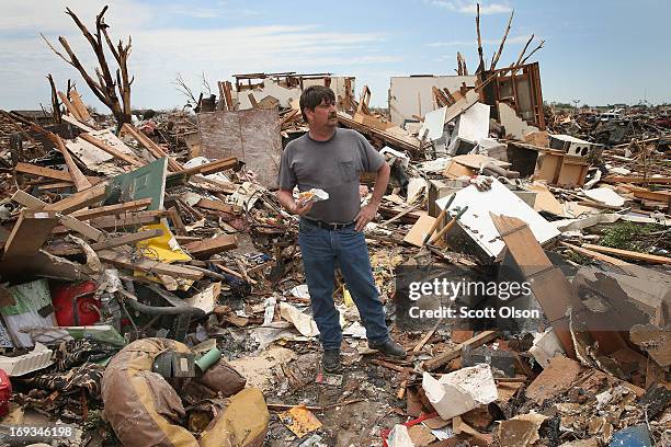 Oklahoma County sheriff’s deputy Kirk Guarnera takes a lunch break in what is left of his home while he continues to salvage items after the home was...