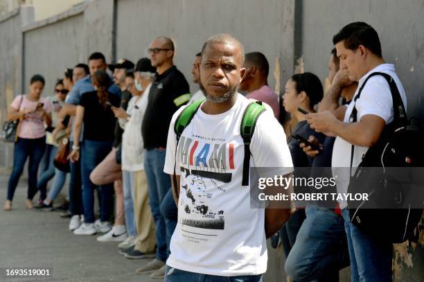 Venezuelan immigrants line up on the pavement outside the Trinidad and Tobago Immigration office on Henry Street, Port of Spain, Trinidad and Tobago...