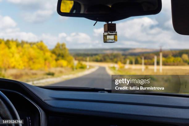 photo of enchanting journey along open road made through car windshield with autumn landscape - windschutzscheibe innen stock-fotos und bilder