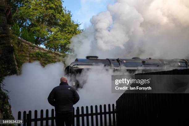 Large cloud of steam surrounds the steam locomotive Black 5 Eric Treacy No. 5428 as it leaves Grosmont Station during the 50th anniversary North...