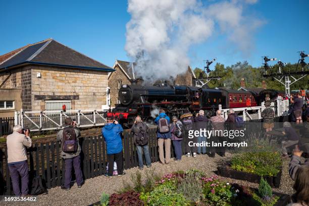 Visitors watch as the steam locomotive Black 5 Eric Treacy No. 5428 leaves Grosmont Station during the 50th anniversary North Yorkshire Moors Railway...
