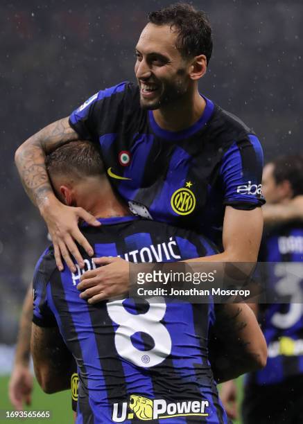 Hakan Calhanoglu of FC Internazionale celebrates with team mate Marko Arnautovic after scoring a second half penalty to give the side a 4-1 lead...