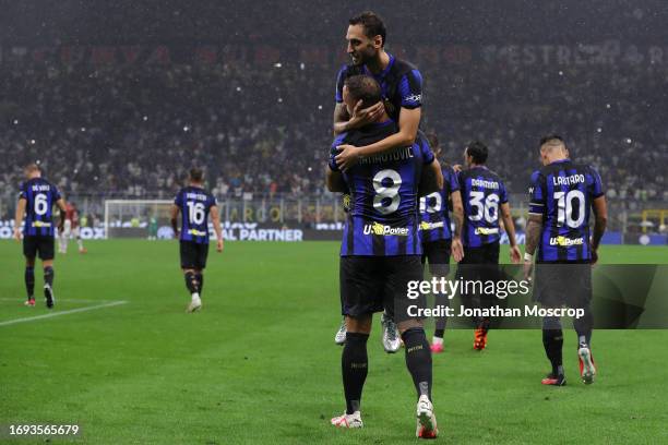 Hakan Calhanoglu of FC Internazionale celebrates with team mate Marko Arnautovic after scoring a second half penalty to give the side a 4-1 lead...