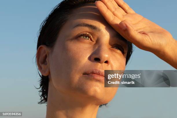 female is  trying to cool down - hyperthermia stockfoto's en -beelden