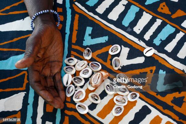 Fortune telling with cauri shells, Senegal.