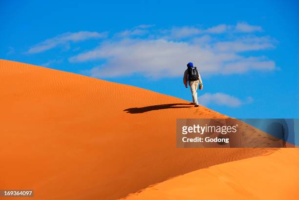 Tourist trekking in Erg Ubari desert, Lybia.
