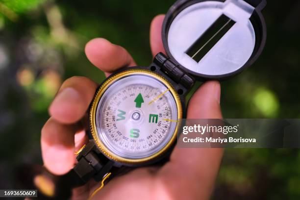 compass in hand close up. - amber alert stock pictures, royalty-free photos & images