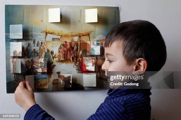 Boy opening an Advent calendar